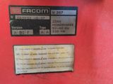 an image of a close up of a red machine with a label on it
