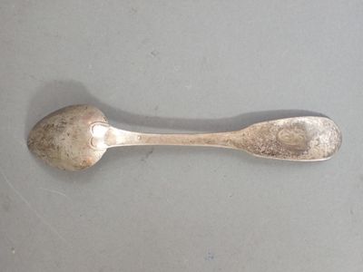a silver spoon and a silver spoon on a table