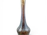 a glass vase that is sitting on a white surface