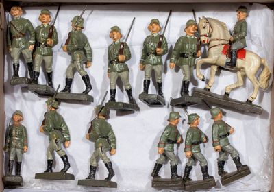 many figurines of men in military uniforms in a box