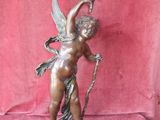 an image of a statue of a cupid holding a candle