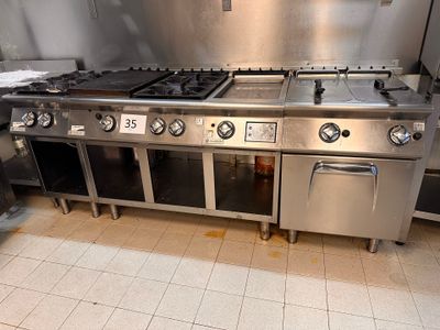a large stainless steel stove in a kitchen with a lot of counter space