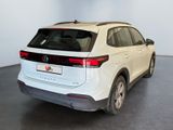 the rear end of a white volkswagen suv parked in a showroom