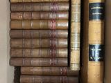 a box full of old books sitting on top of each other