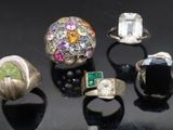 five different rings on a black surface with a black background