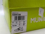 a green box that has a pair of shoes in it