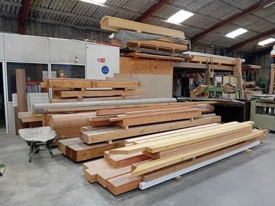 many pieces of wood stacked on top of each other in a building