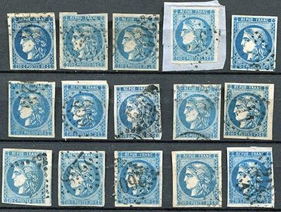 an assortment of blue and white stamps on a black surface