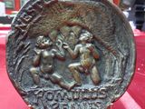 a close up of a coin on a table with a red cloth