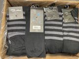 trois paires de chaussettes noires et grises pour homme dans une boîte