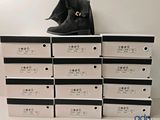 a stack of boxes with a pair of shoes on top of them