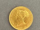 a close up of a gold coin with a woman ' s head on it