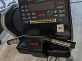 a laptop on a stationary exercise bike in a gym