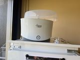 a white microwave sitting on top of a white refrigerator