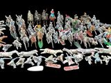 a large group of toy animals that are on a black background