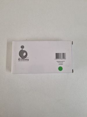 a close up of a white box with a green sticker on it