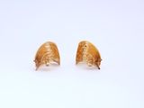 a pair of gold earrings on a white background