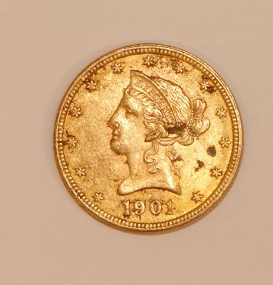 a close up of a gold coin with a woman ' s head on it