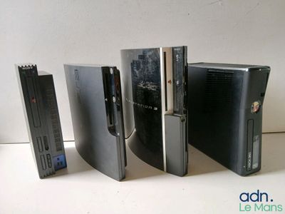 Plusieurs types de consoles de jeux vidéo sont alignés sur une table