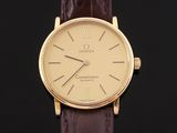 a close up of a gold wrist watch on a black background