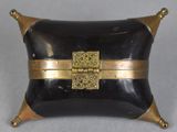 a black and gold box with a gold buckle on it