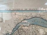 a picture of a map of france on display in a glass case