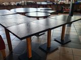 tables and chairs in a restaurant with tiled flooring and red chairs