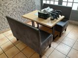 a table with two chairs and a coffee maker on it