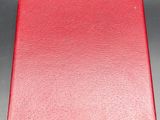 a red leather case with a gold clasp on it