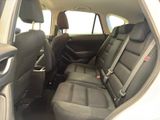 the back seats of a white car with a black seat belt