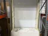 an empty refrigerator in the middle of a room