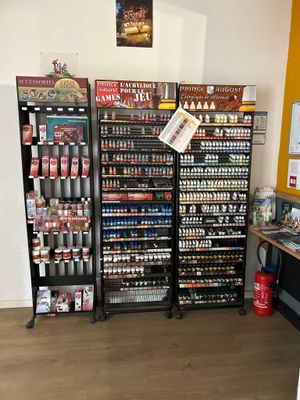 many shelves of beer in a store with a sign on the wall