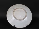 a white plate on a stand on a black background