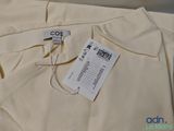 a label on a white shirt that says cos