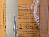 a cardboard box with a label on it sitting on the floor