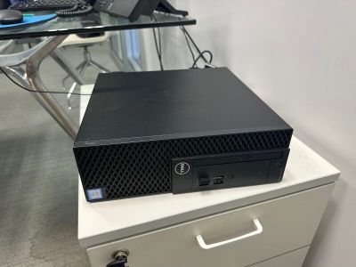 a computer on top of a filing cabinet in an office