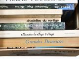 many books stacked on top of each other in a box