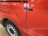 a close up of a red van with a sticker on it