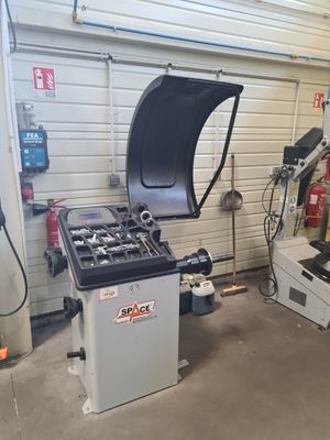 a machine that is sitting in a garage next to another machine