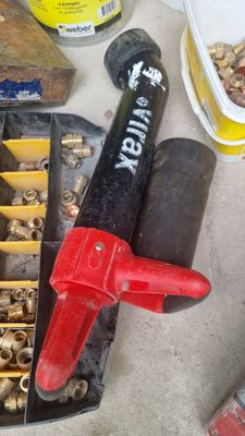 a red fire hydrant sitting on a table next to a bunch of screws