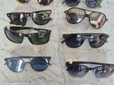 several pairs of sunglasses sitting on a table with a price tag
