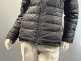 an image of a mannequin wearing a black jacket and white pants