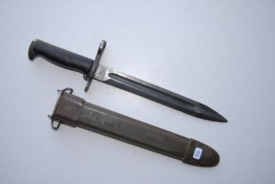 two different types of knives on a white surface