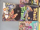 several comics are stacked on top of each other on a table
