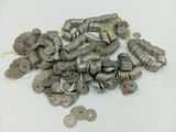 a pile of silver coins on a white surface