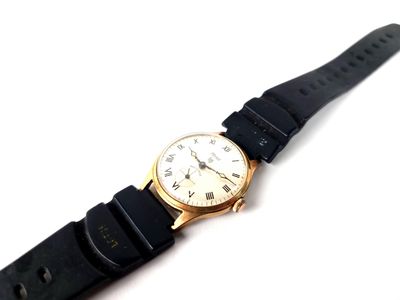 an image of a close up of a wrist watch on a white surface