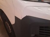 the front end of a white van with a black bumper