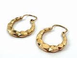 pair of gold tone hoop earrings with geometric design on a white background