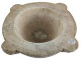 a stone vase that is sitting on a white surface