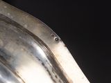 a close up of a metal object with a black background